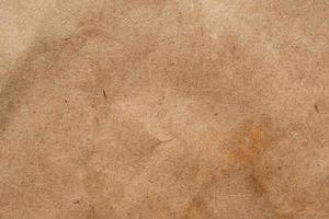 Brown crumpled paper recycled kraft sheet texture background photo