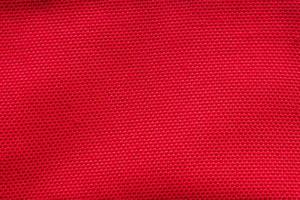 Red fabric cloth texture background close up photo