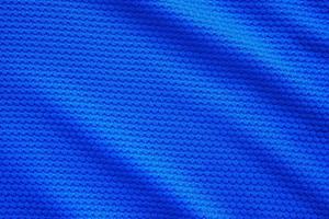 Blue football jersey clothing fabric texture sports wear background, close up top view photo