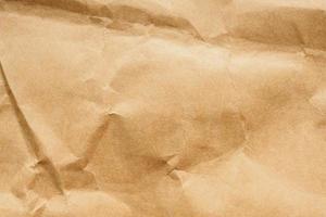 Brown crumpled paper recycled kraft sheet texture background photo