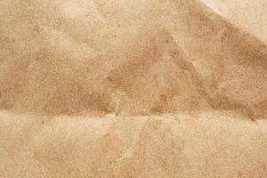 Brown crumpled paper recycled kraft sheet texture background photo