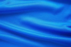 Blue football jersey clothing fabric texture sports wear background, close up top view photo