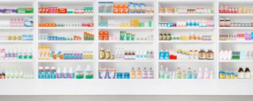 Empty wood counter top with pharmacy drugstore shelves blur pharmaceutical medicine product background photo