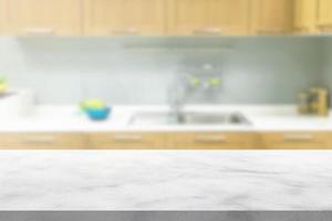 white marble stone counter top with blurred kitchen background photo