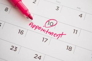 important appointment schedule write on white calendar page date close up photo