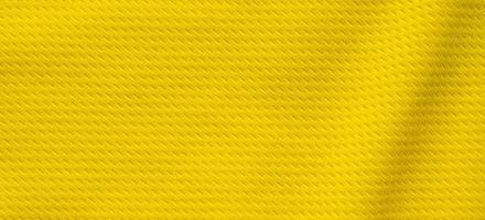 Yellow sports clothing fabric football shirt jersey texture close up photo