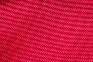 Red fabric cloth texture background close up photo