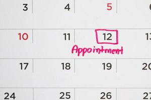 important appointment schedule write on white calendar page date close up photo