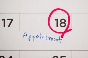 important appointment schedule write on white calendar page date close up photo