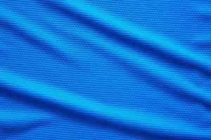 Blue football jersey clothing fabric texture sports wear background, close up top view photo