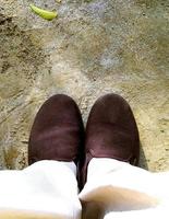 Top view of a pair of brown sneakers shoes on concrete floor background. photo