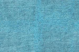 Seamless texture background of light blue denim fabric photo