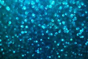 defocused abstract background glittering with bright blue sparkles photo