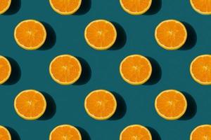 seamless pattern of ripe tasty orange cut in half on a blue background photo