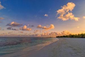 Landscape of paradise tropical island beach. Silhouette of palm trees beautiful sunset sky, dream sea beach background for travel in holiday relax tourism. Closeup view of waves sunrise seaside nature photo