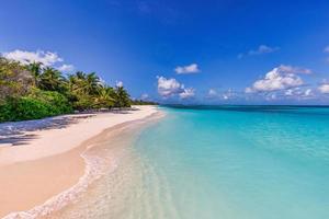 Beautiful tropical beach relaxing sky at exotic island with palm trees calm waves and amazing blue ocean lagoon. Paradise nature destination, idyllic outdoor scene for summer travel vacation, inspire photo