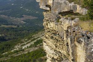 Mountain valley with a sheer cliff, mountain peak, mountain landscape, top view. photo