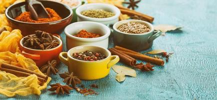 Spices and condiments in small bowls photo