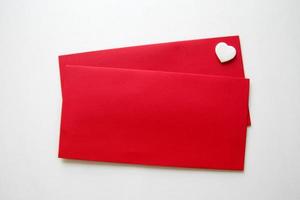 Two red envelopes with one heart for Valentine's Day. photo
