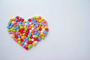 A lot of the little shining colorful hearts in one big heart for Valentine's Day. photo