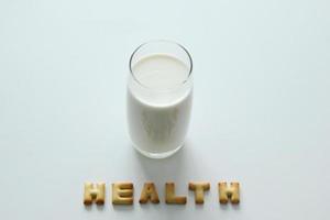 A glass of milk with inscription from the cookies on the white background. photo