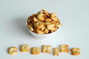 A bowl of cookies with inscription from the cookies on the white background. photo