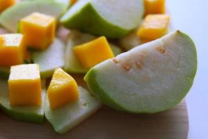 Fresh fruits - guava and mango on the white background. photo