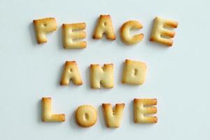 An inscription from the cookies on the white background. Text - Peace and love. photo