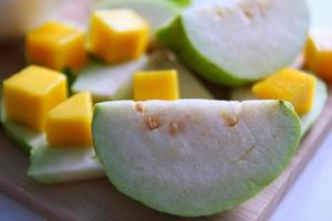 Fresh fruits - guava and mango on the white background. photo