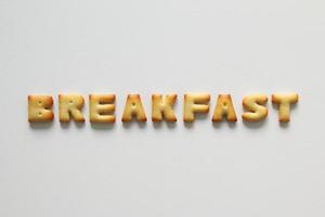 An inscription from the cookies on the white background. Text - breakfast. photo