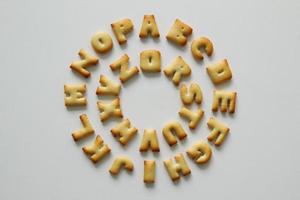 An English alphabet from the cookies in a circle on the white background. photo