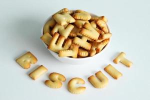 A bowl of cookies with inscription from the cookies on the white background. photo