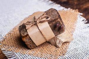 Piece of handmade soap with coffee beans. Spa concept for massage and relax. photo