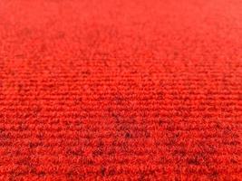 Red woolen carpet background with perspective view, selective focus photo