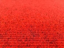 Red woolen carpet background with perspective view, selective focus photo