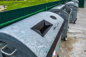 metal trash cans for separate waste collection in a densely populated area of the city photo