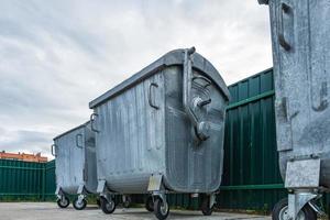 metal trash cans for separate waste collection in a densely populated area of the city photo