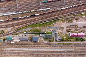 aerial view over long railway freight trains with lots of wagons stand on parking photo