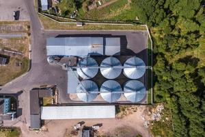 aerial view on rows of agro silos granary elevator with seeds cleaning line on agro-processing manufacturing plant for processing drying cleaning and storage of agricultural products photo