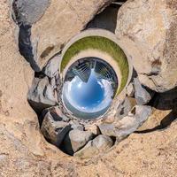 blue sphere little planet inside gravel road and pebbles. curvature of space photo
