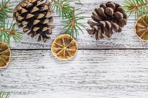 Christmas fir branches with cones and dry lemon slice photo