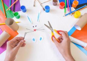 step 2. DIY paper rabbit from a roll of toilet paper. Easy craft for kids on white background, simple DIY idea from toilet tube, recycling concept. Gift ideas, decor for spring, photo