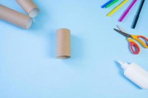 Festive easy DIY craft for children. Roll of toilet paper toy bear on a blue background. Creative decoration eco friendly, reuse, recycling, minimal waste free handmade concept photo