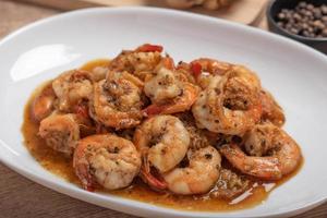 Fried prawns with black pepper and garlic in a white plate photo