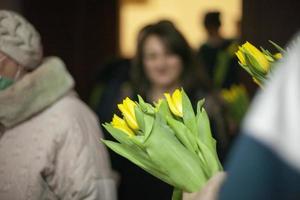 Bouquet of flowers for guests. Yellow flowers for women. Details of holiday. photo