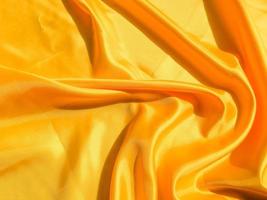 Beautiful yellow silk or satin texture background with copy space for design and artwork photo