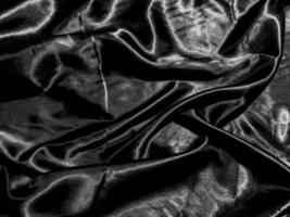 luxury black silk or satin texture background with liquid wave or wavy folds. Wallpaper design photo