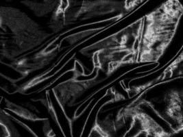 Black cloth or fabric exture background with liquid wave or wavy folds. Wallpaper design photo