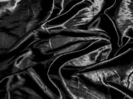 luxury black silk or satin texture background with liquid wave or wavy folds. Wallpaper design photo