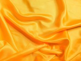 Yellow silk or satin texture background with copy space for design photo